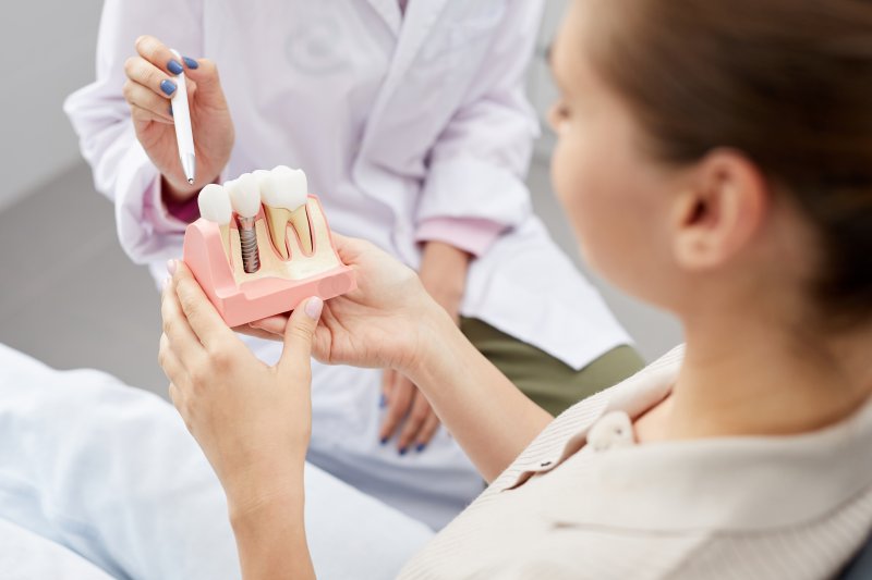 A dentist talking to their patient during a dental implant consultation